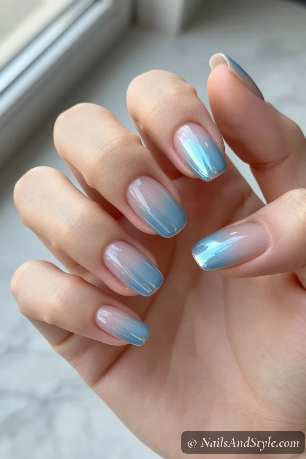 Icy blue chrome half-moon nails