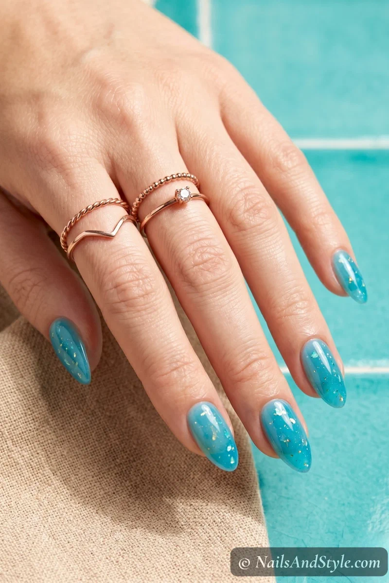Sheer blue lagoon jelly nails in aqua blue on medium almond nails