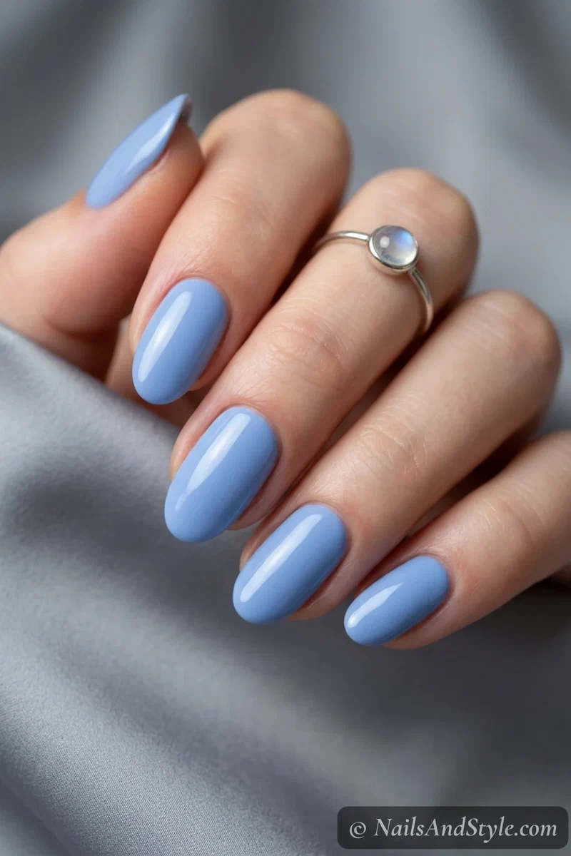Cornflower blue nails with a soft powdery blue cream and glossy finish on medium oval nails