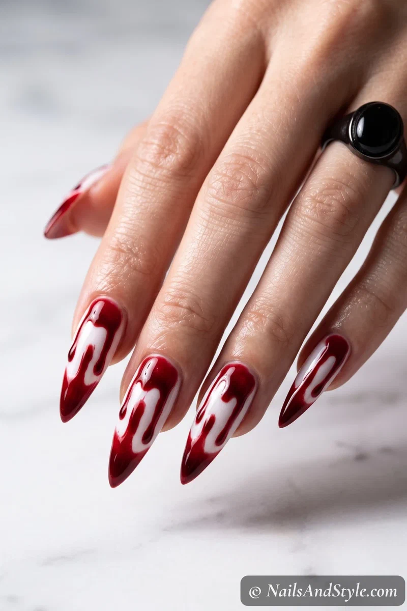Long white stiletto nails with thick red gore dripping down