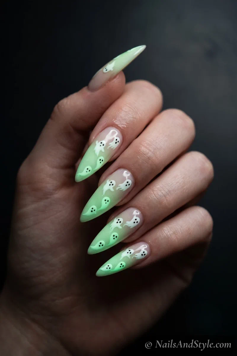 Long dark nails with a trail of white ghosts glowing green