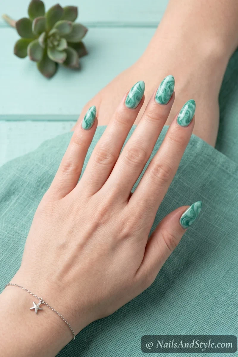 Marbled seafoam green mermaid nails with organic swirl pattern