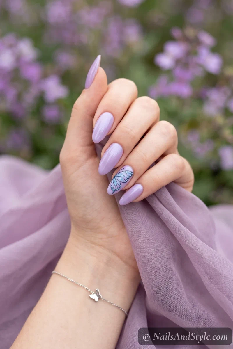 lavender nails with delicate blue butterfly wing design on accent nail