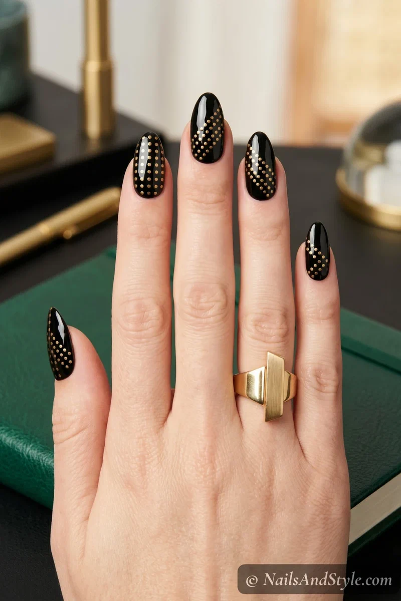 black nails with gold geometric dot grid pattern