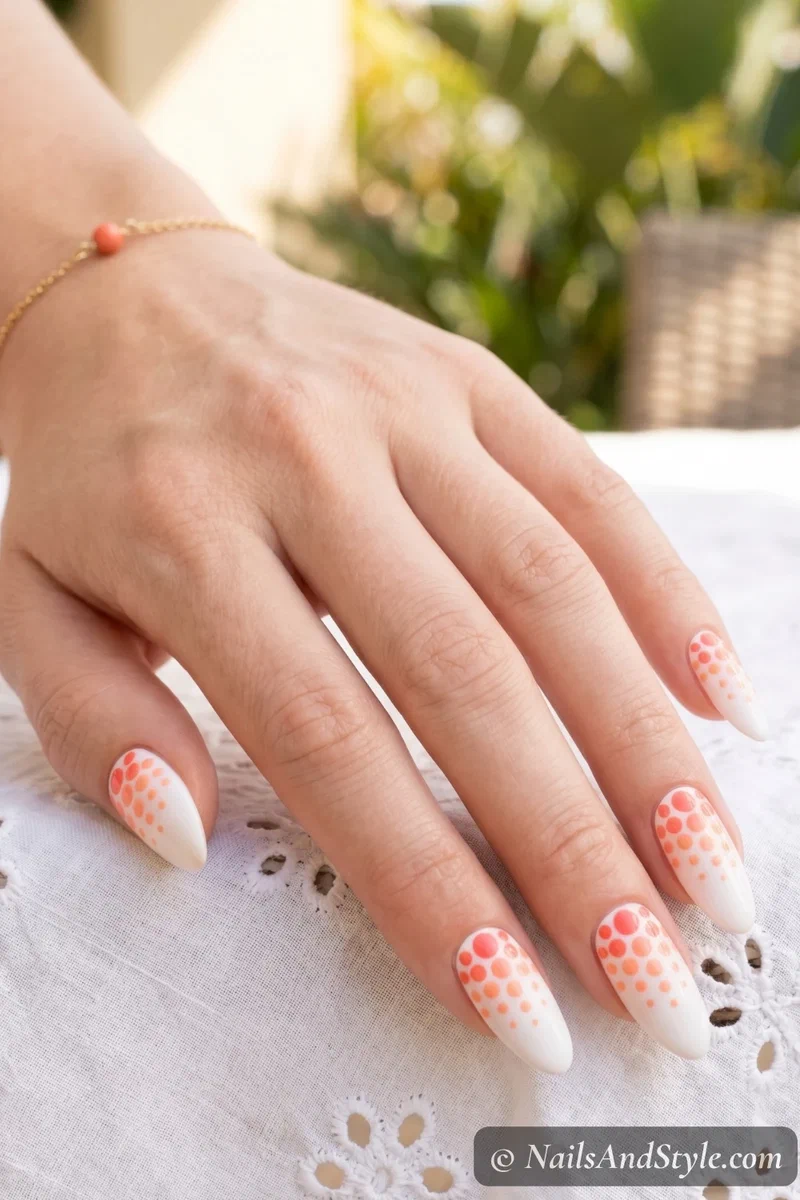 white nails with coral ombre dot gradient from base to tip