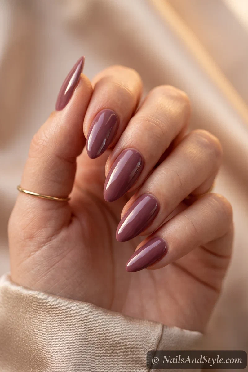 Almond nails tapering to a soft rounded point in a glossy mauve