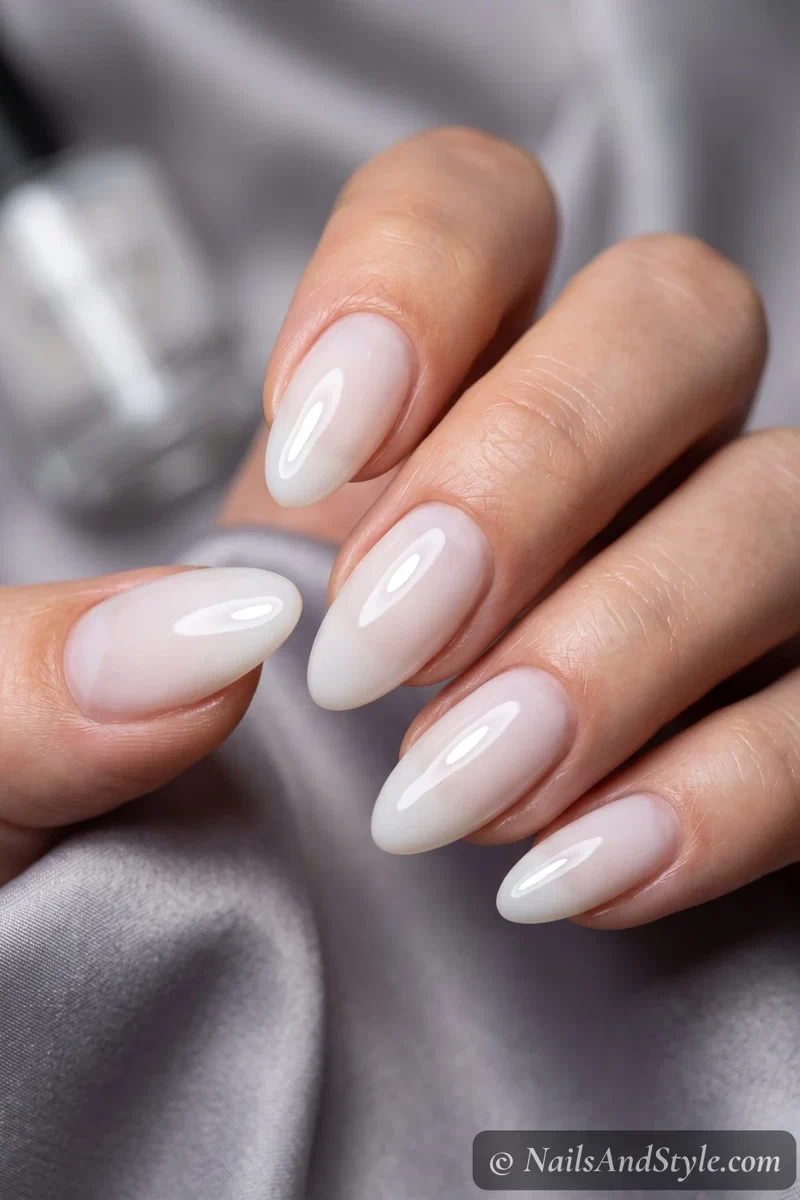 Glossy milky white semi-cured gel strip manicure with a wet-look shine on medium almond nails