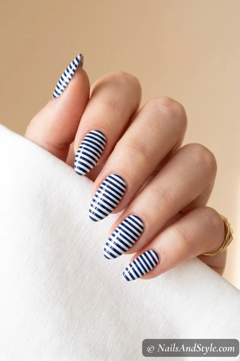 Navy and white horizontal striped nails with clean even lines
