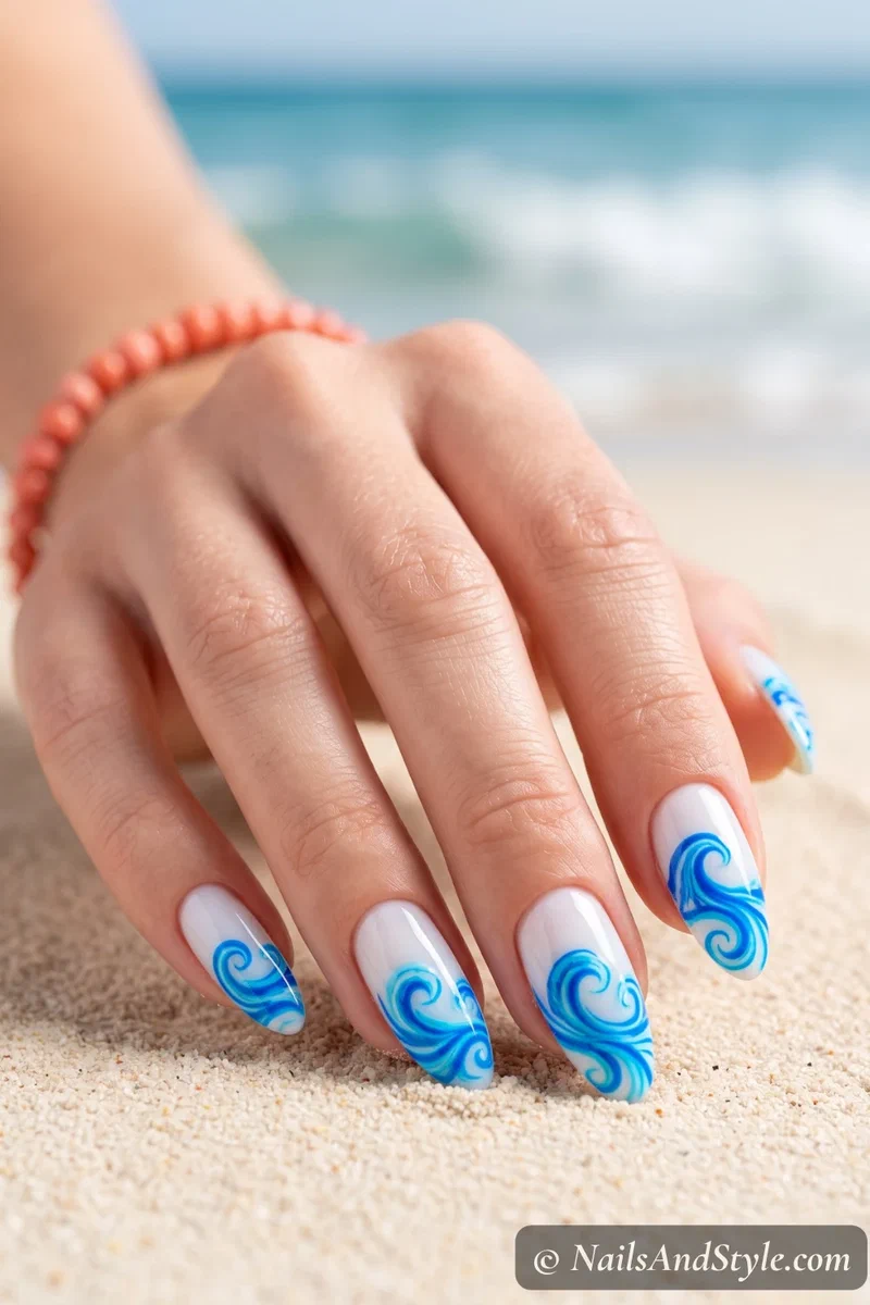 White nails with neon blue ocean wave designs