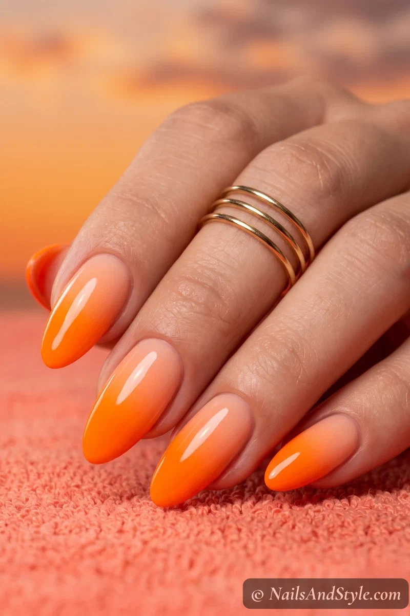 Electric orange ombre nails fading from light to dark