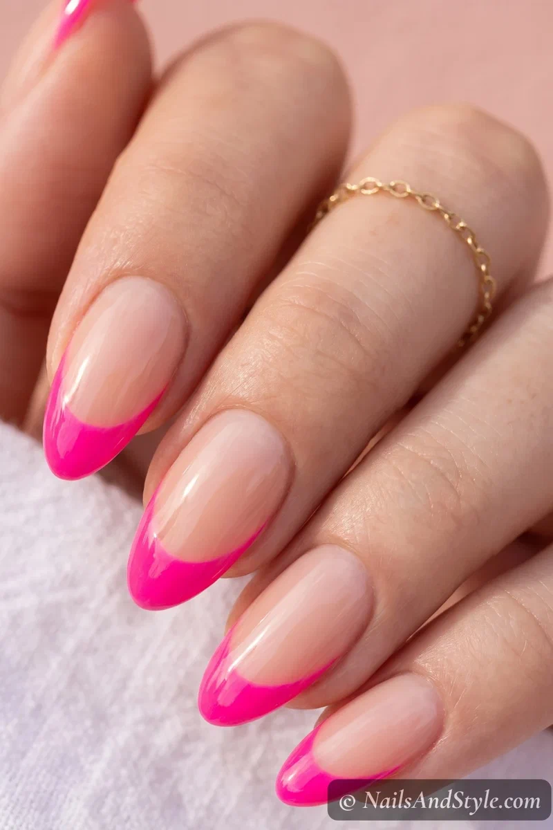 Hot pink neon French tip nails on medium almond shape
