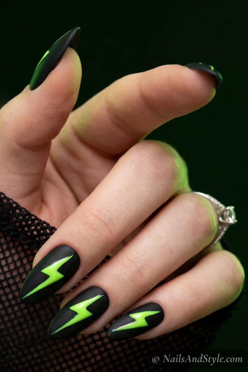 Black nails with neon lime lightning bolts