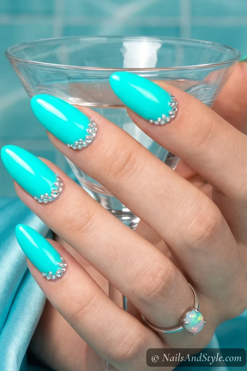 Neon aqua nails with rhinestone cuticle clusters