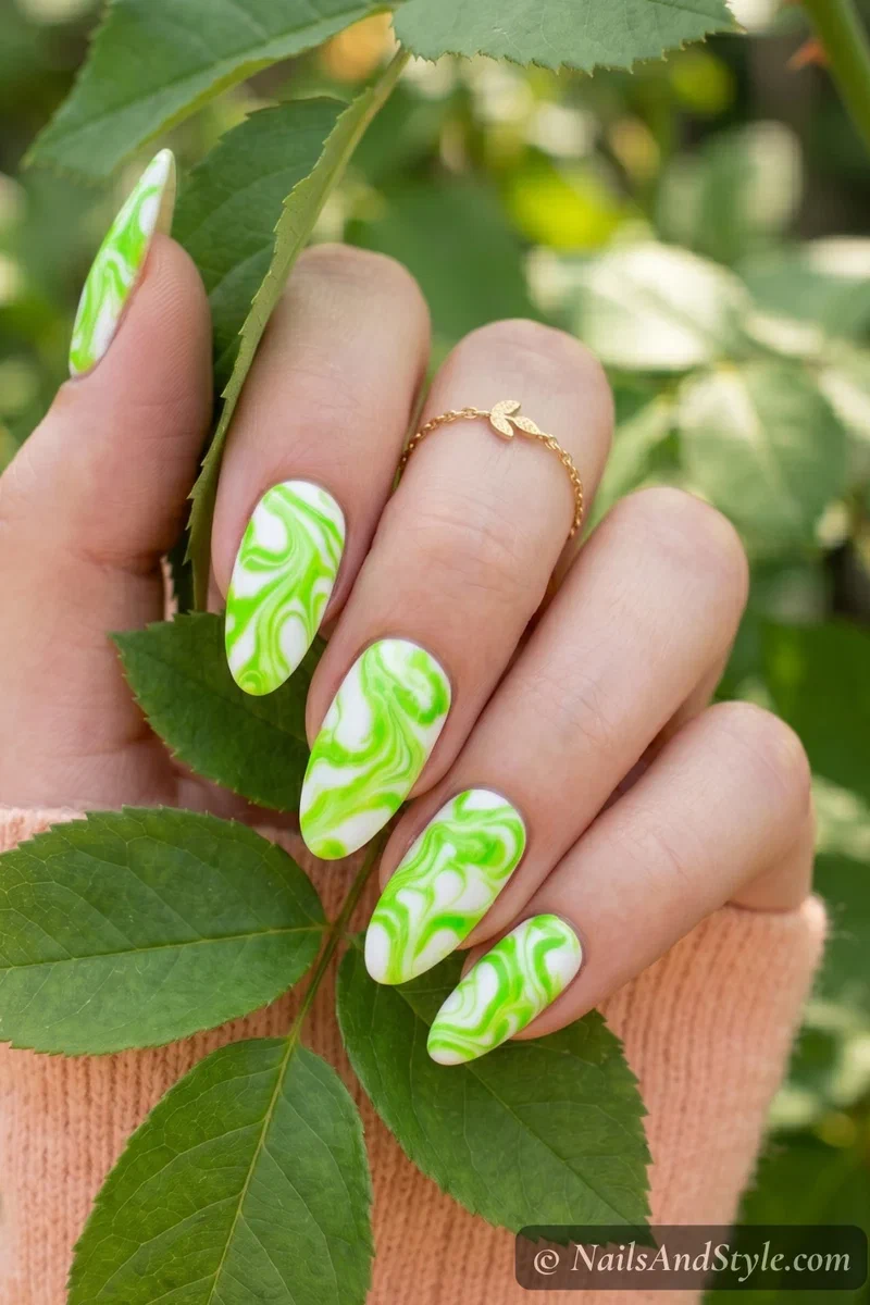 Electric lime green marble nails with white base and organic swirl pattern