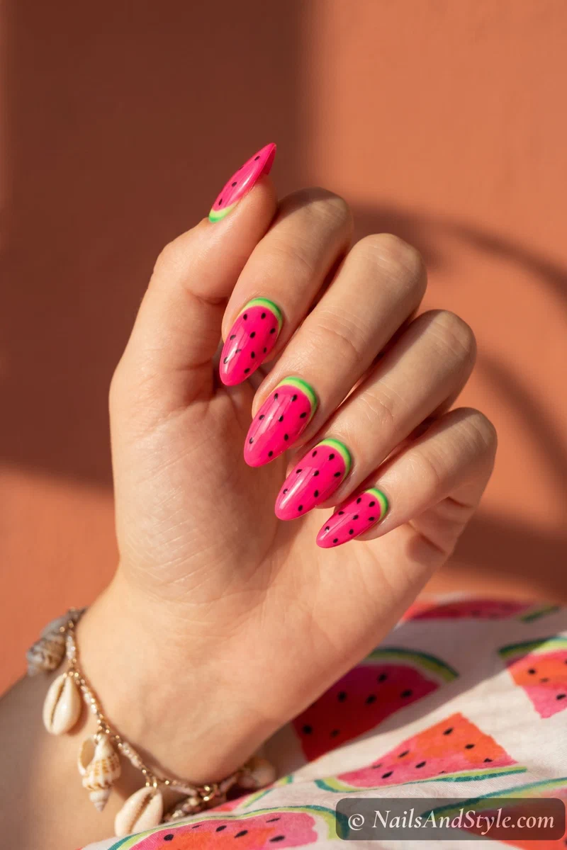 Neon pink watermelon nail design with green rind and black seeds