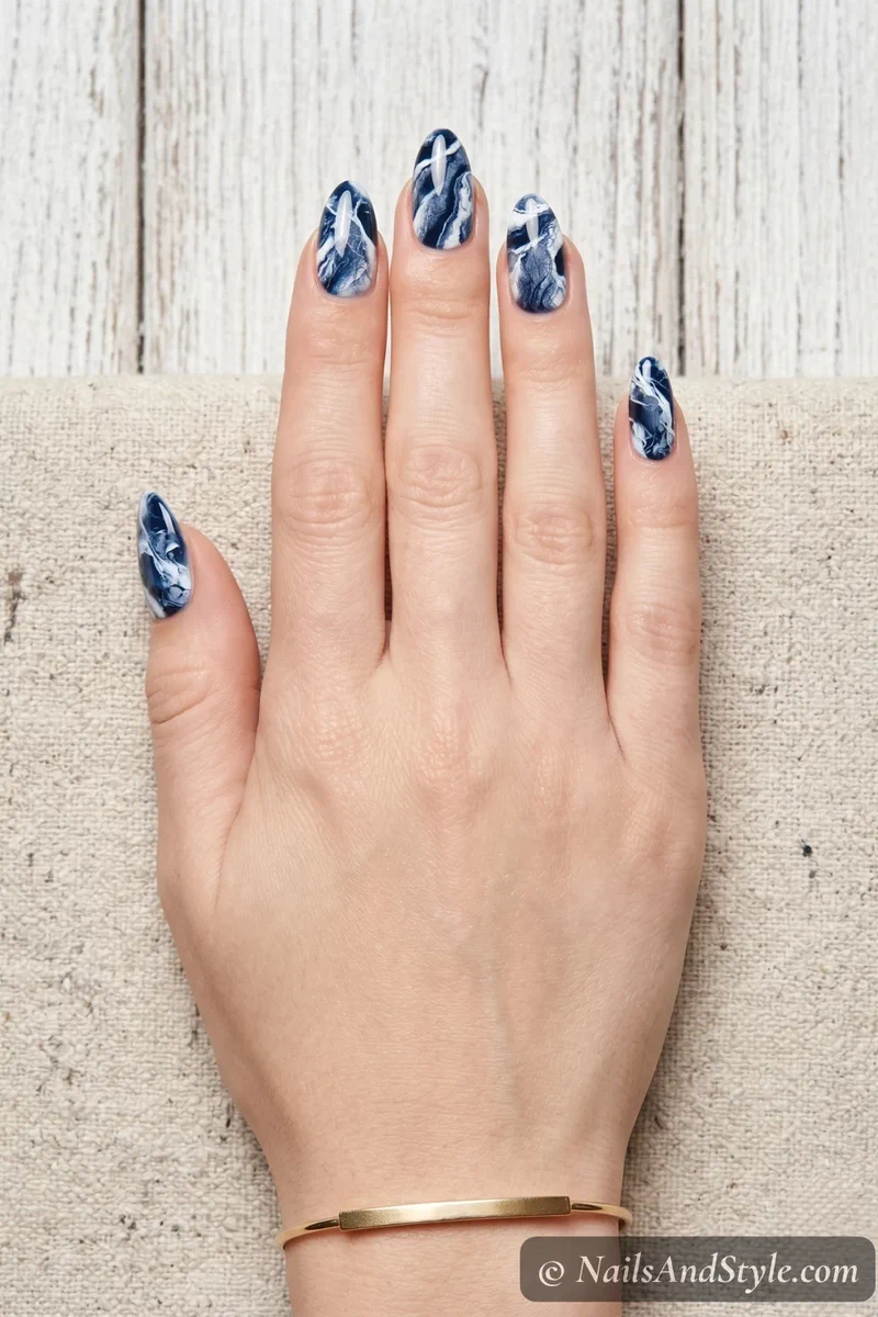 Navy and white abstract marble nails created with plastic wrap technique