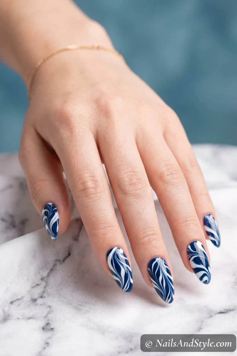 Navy and white water marble nails with organic swirl pattern