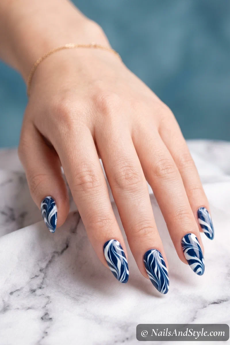 Navy and white water marble nails with organic swirl pattern