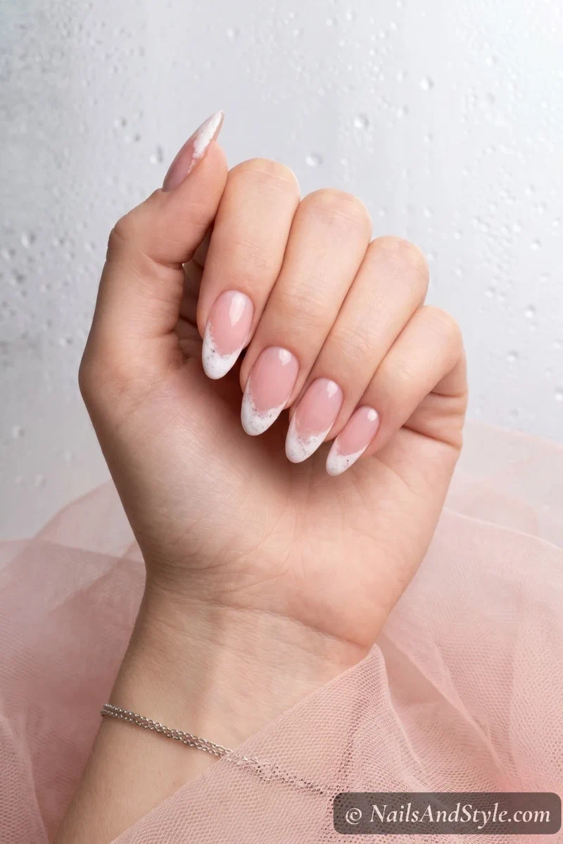 Sheer pink base nails with sponged white foam effect French tips
