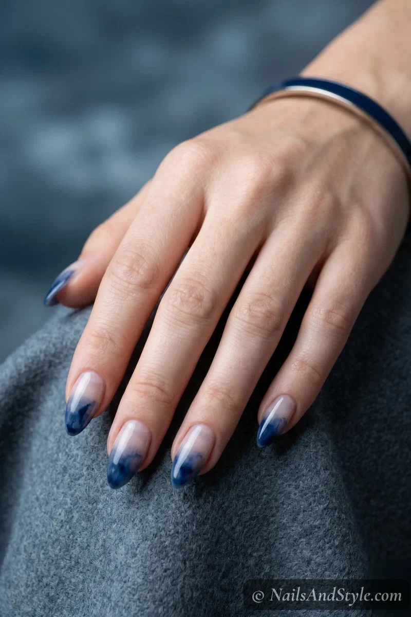 Sheer base nails with watercolor navy blue French tip wash