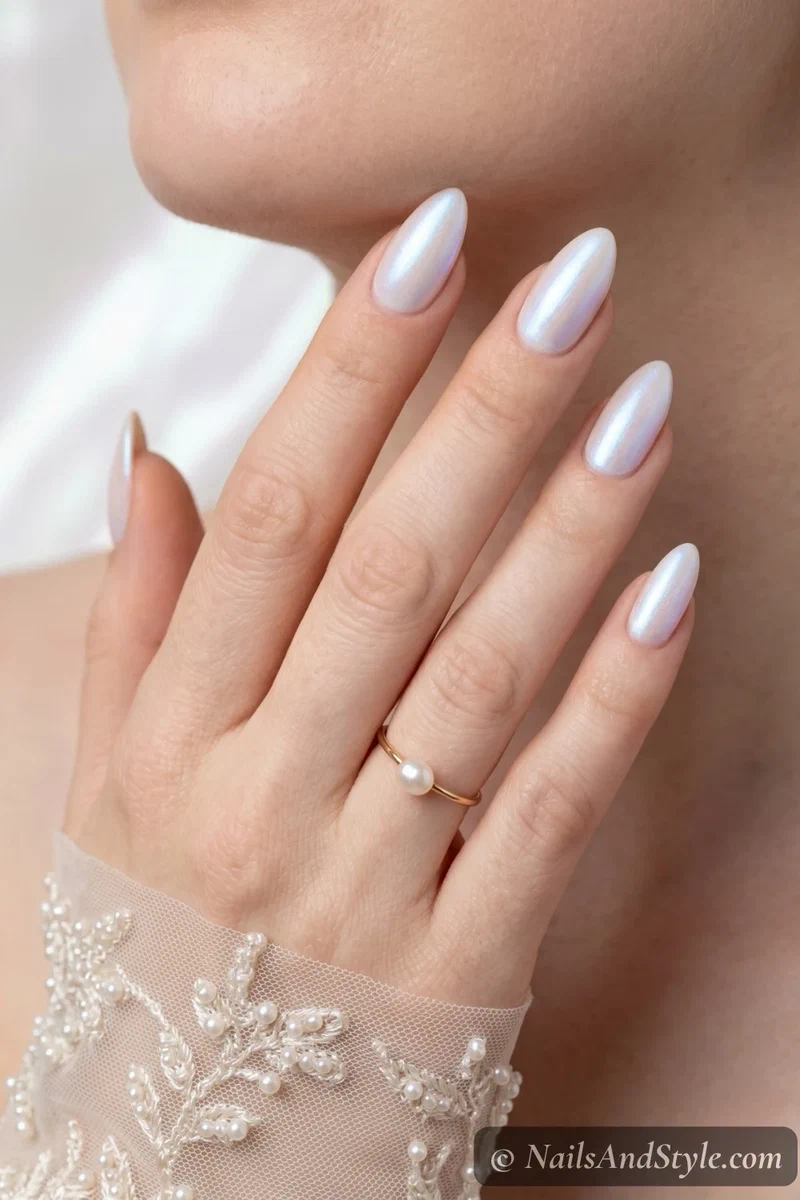 White pearl shimmer nails with iridescent blue-pink shift