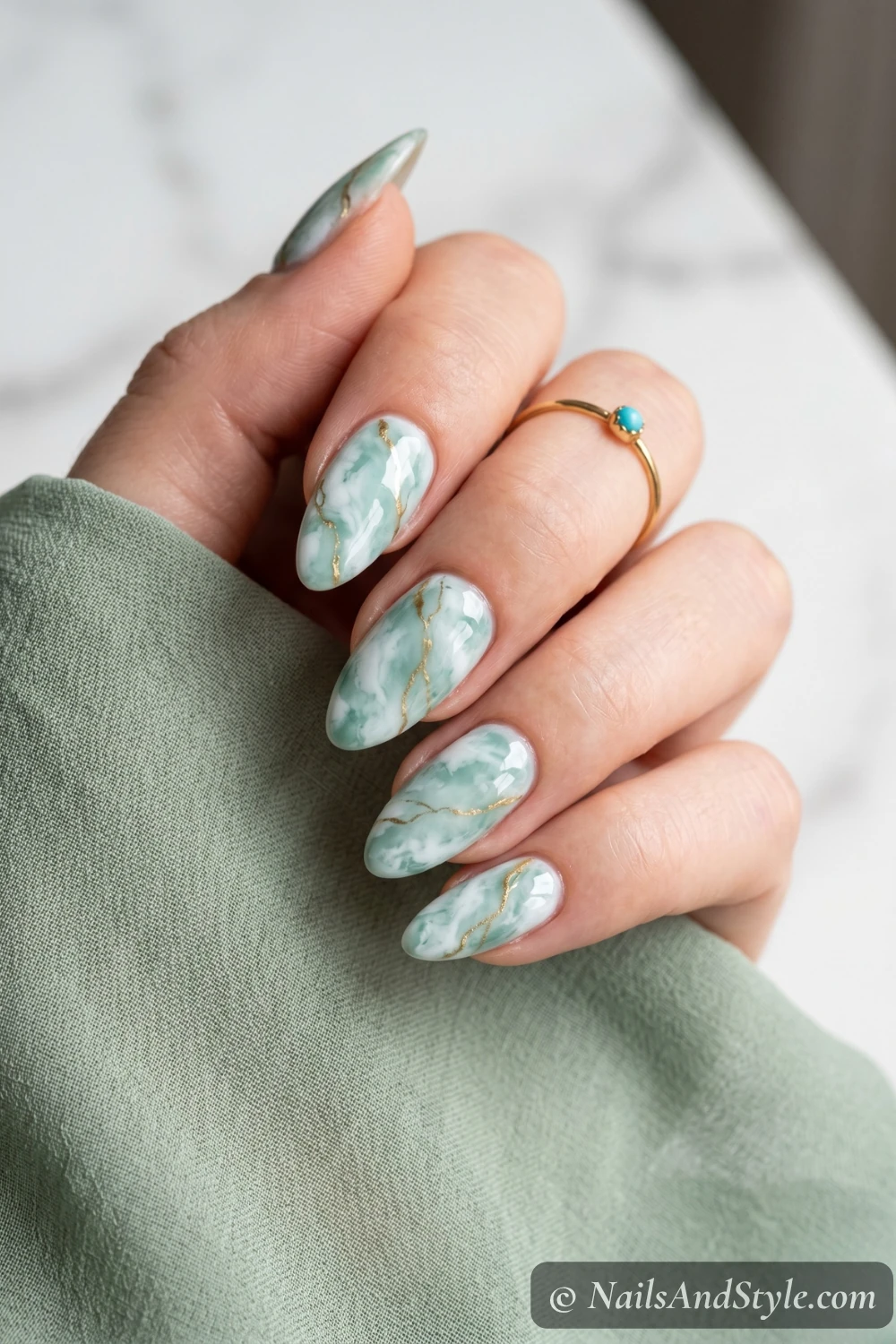 Seafoam and white marble nails with gold veins