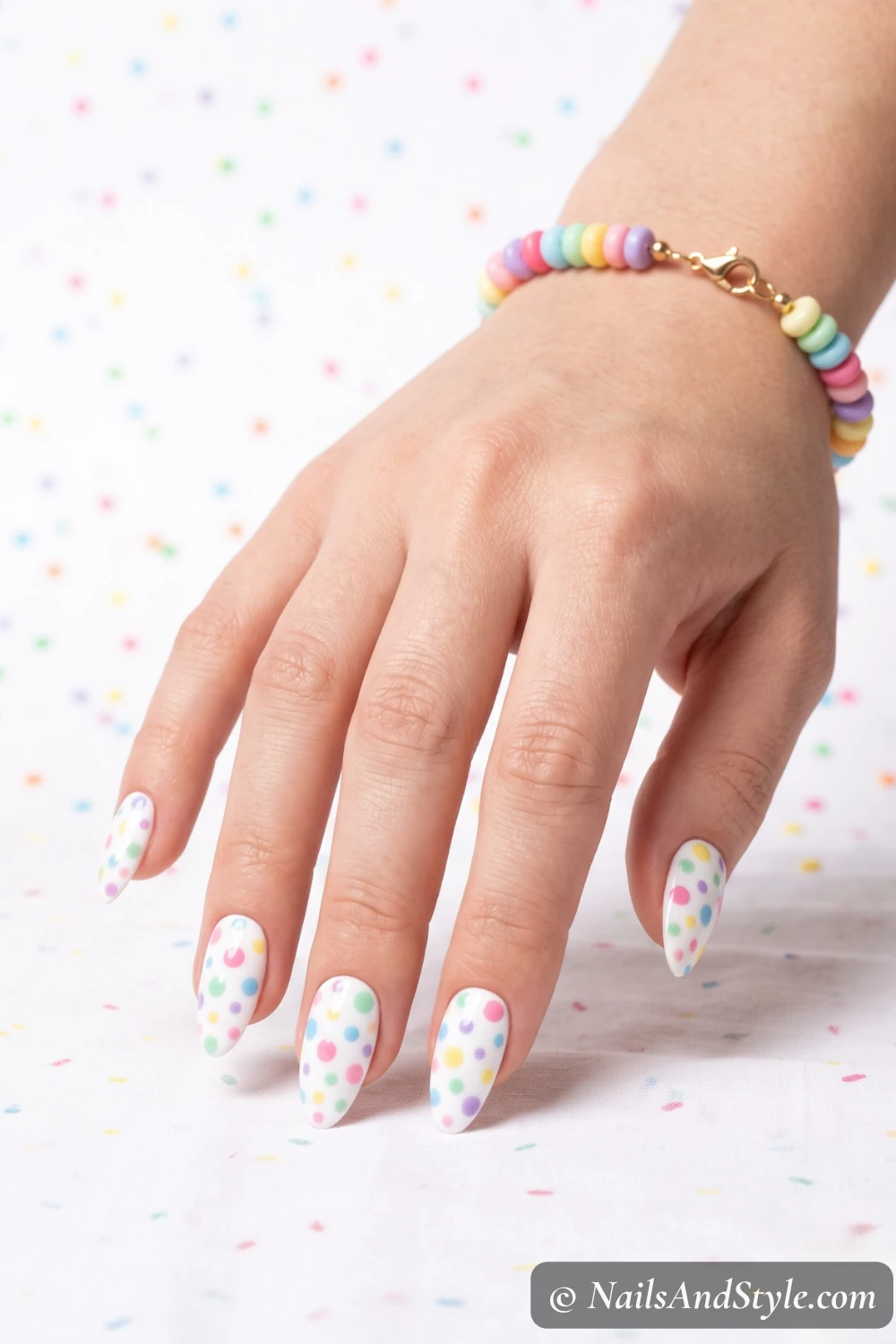 White nails with pastel polka dots