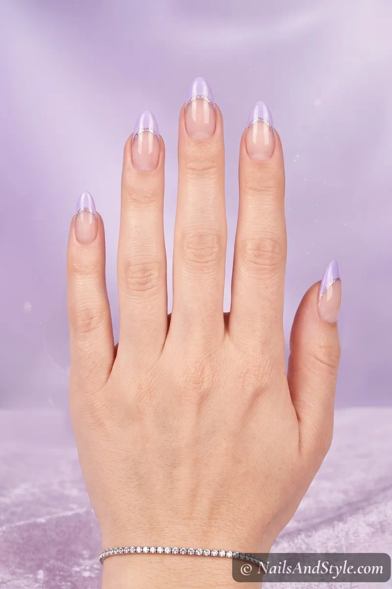 Sheer base nails with lavender French tips and holographic glitter accent line