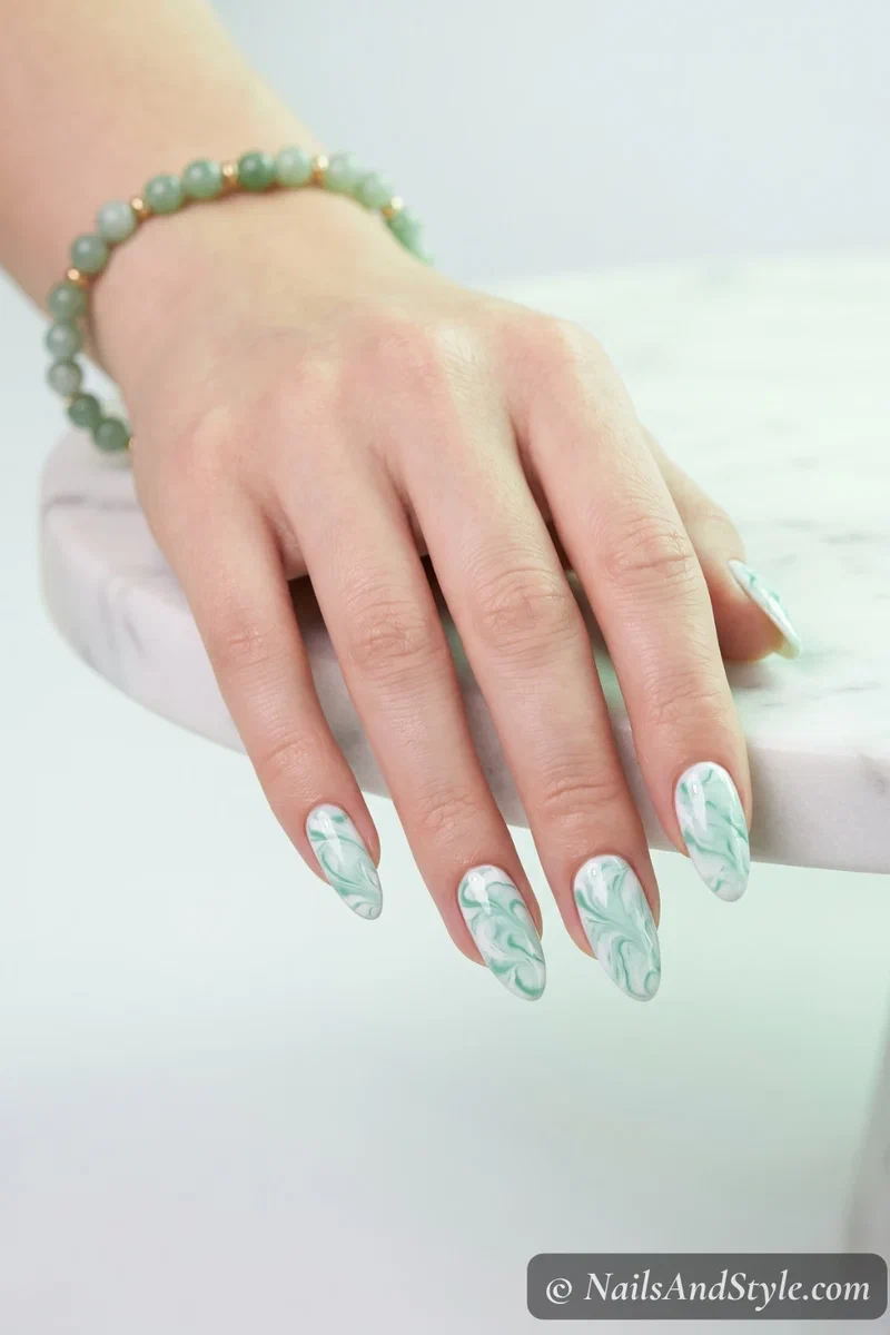 White and mint green marble swirl nails with organic pattern