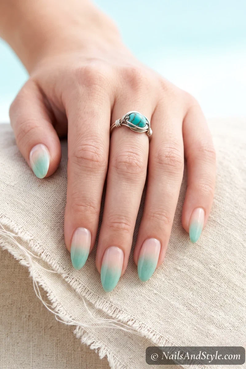 Natural base nails with sponged seafoam green fade at the tips