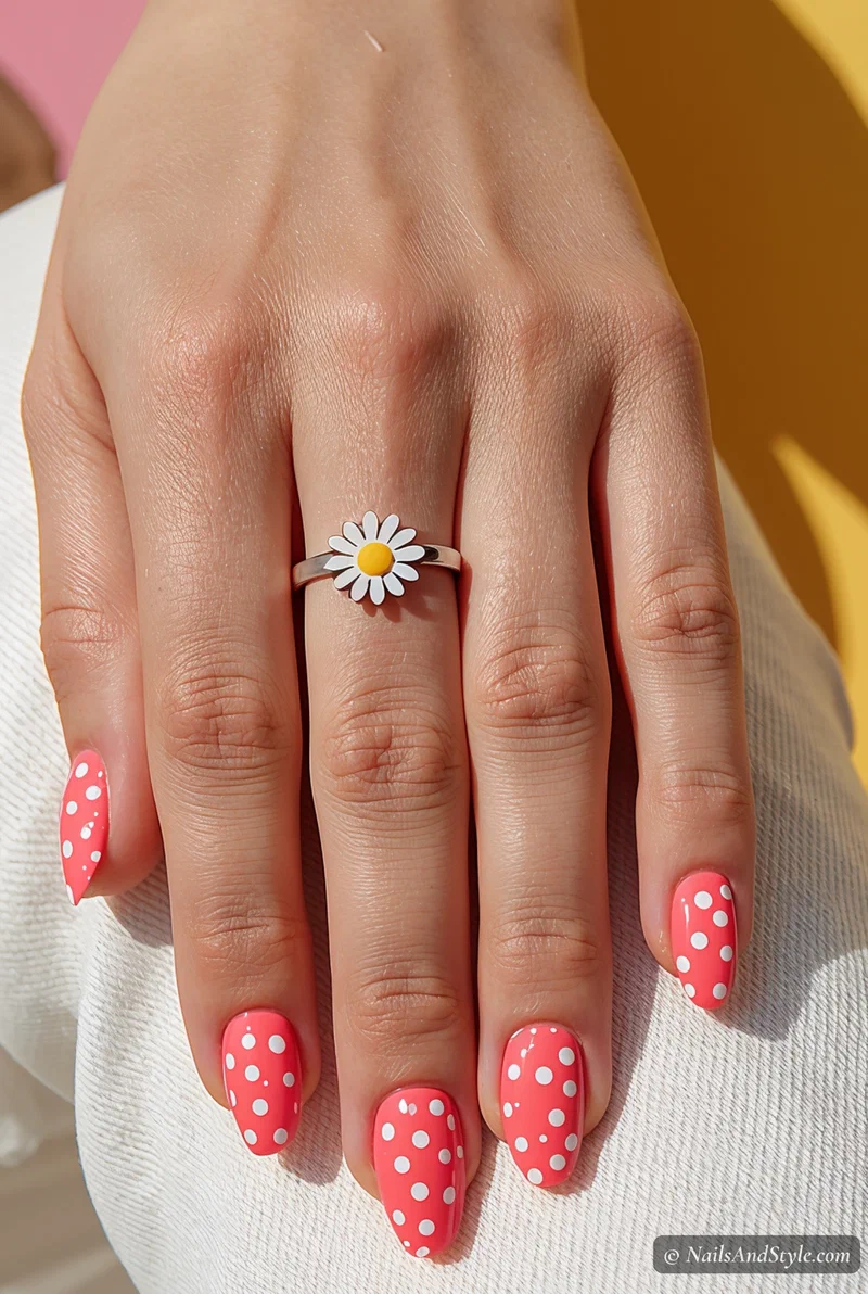 Bubblegum pink nails with scattered white polka dots