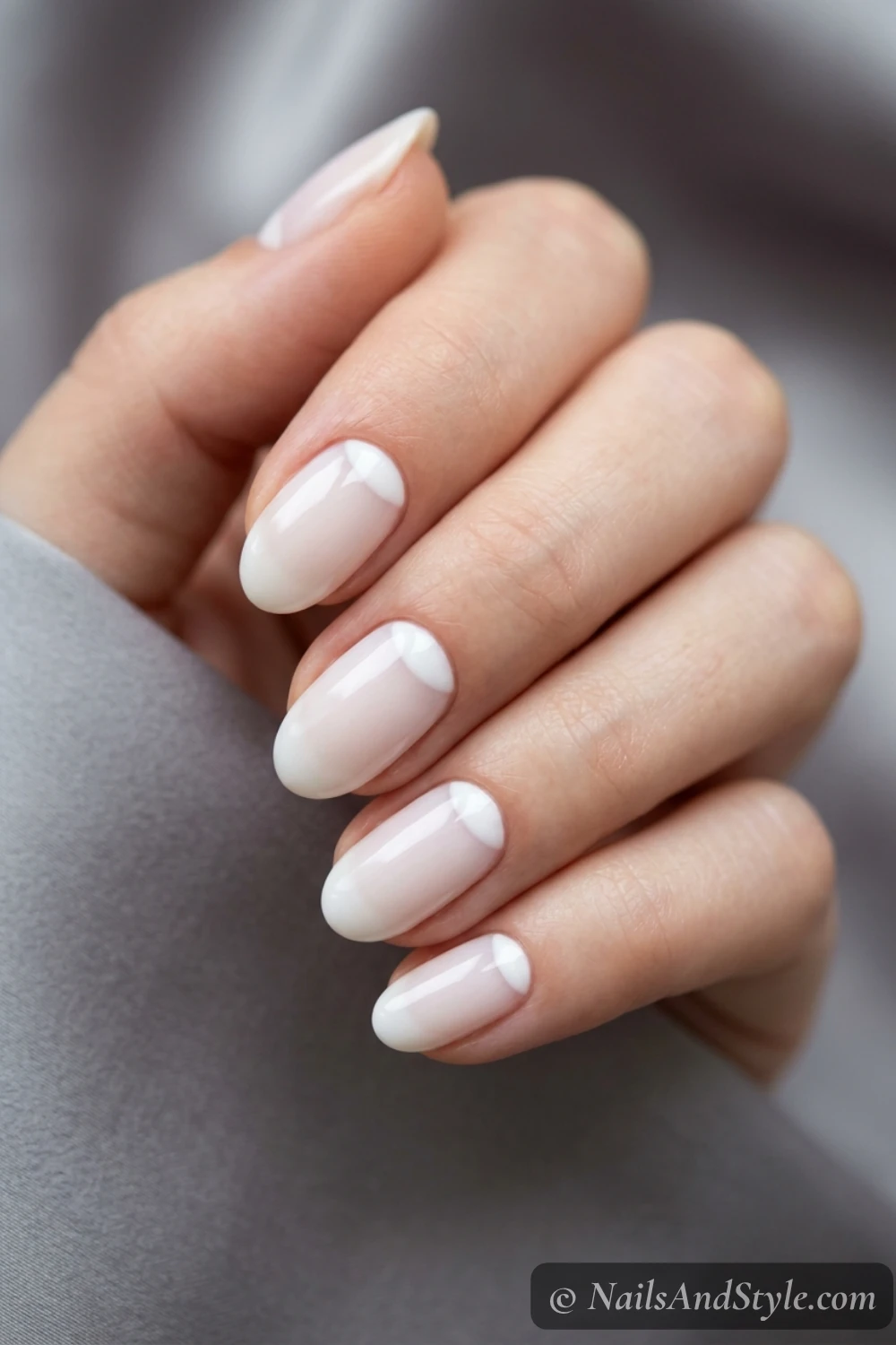 Milky nails with soft white reverse French half-moons