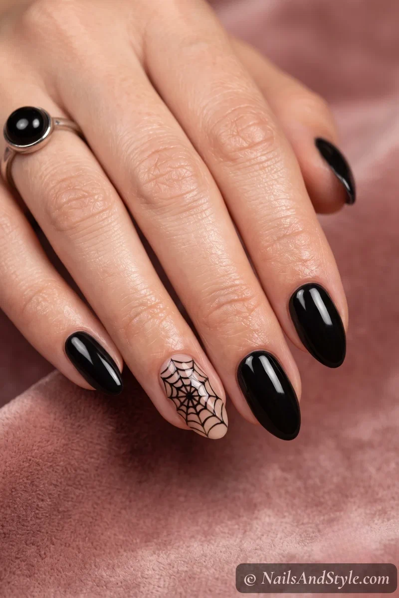 Short nails with one full black spider web accent nail