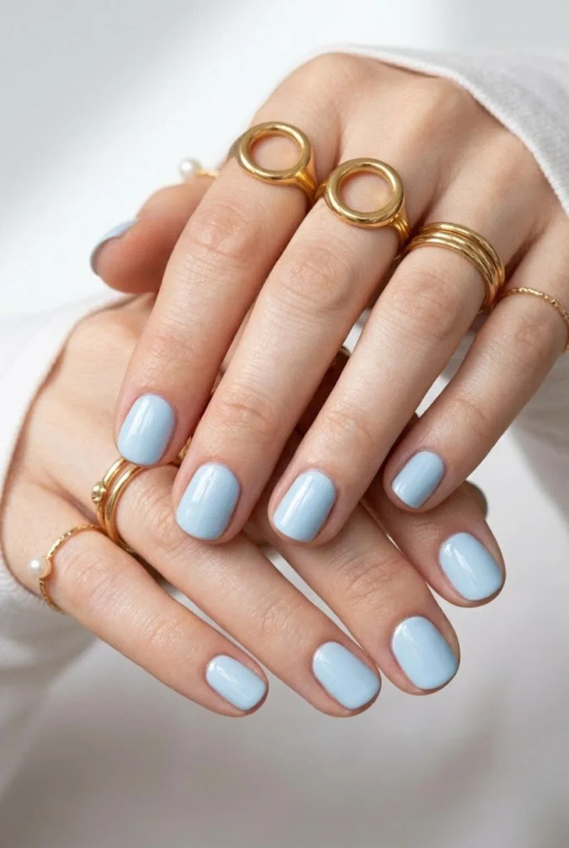 Baby blue glossy nails on short round nails