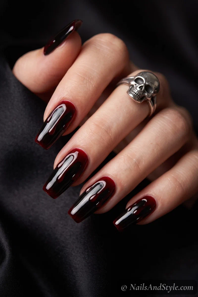 Black nails with thick deep red gore dripping down from the cuticle