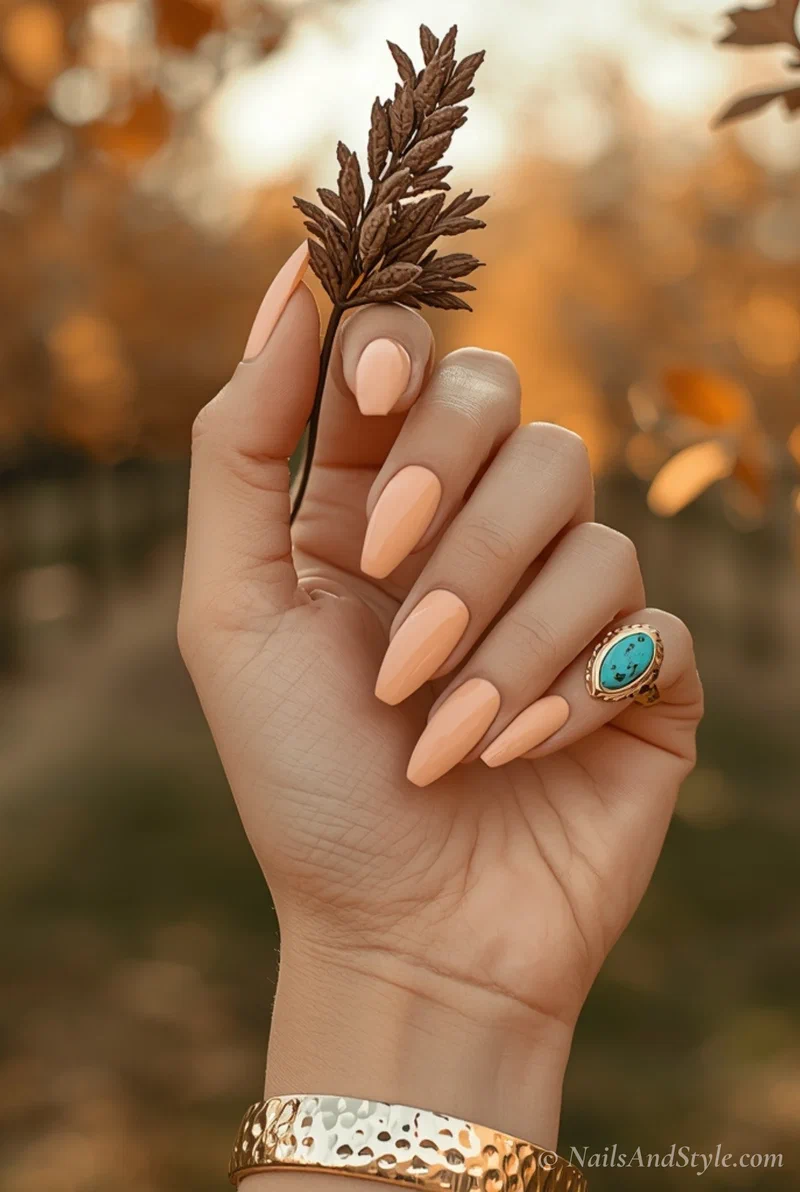 Peach cream acrylic nails on medium almond shape