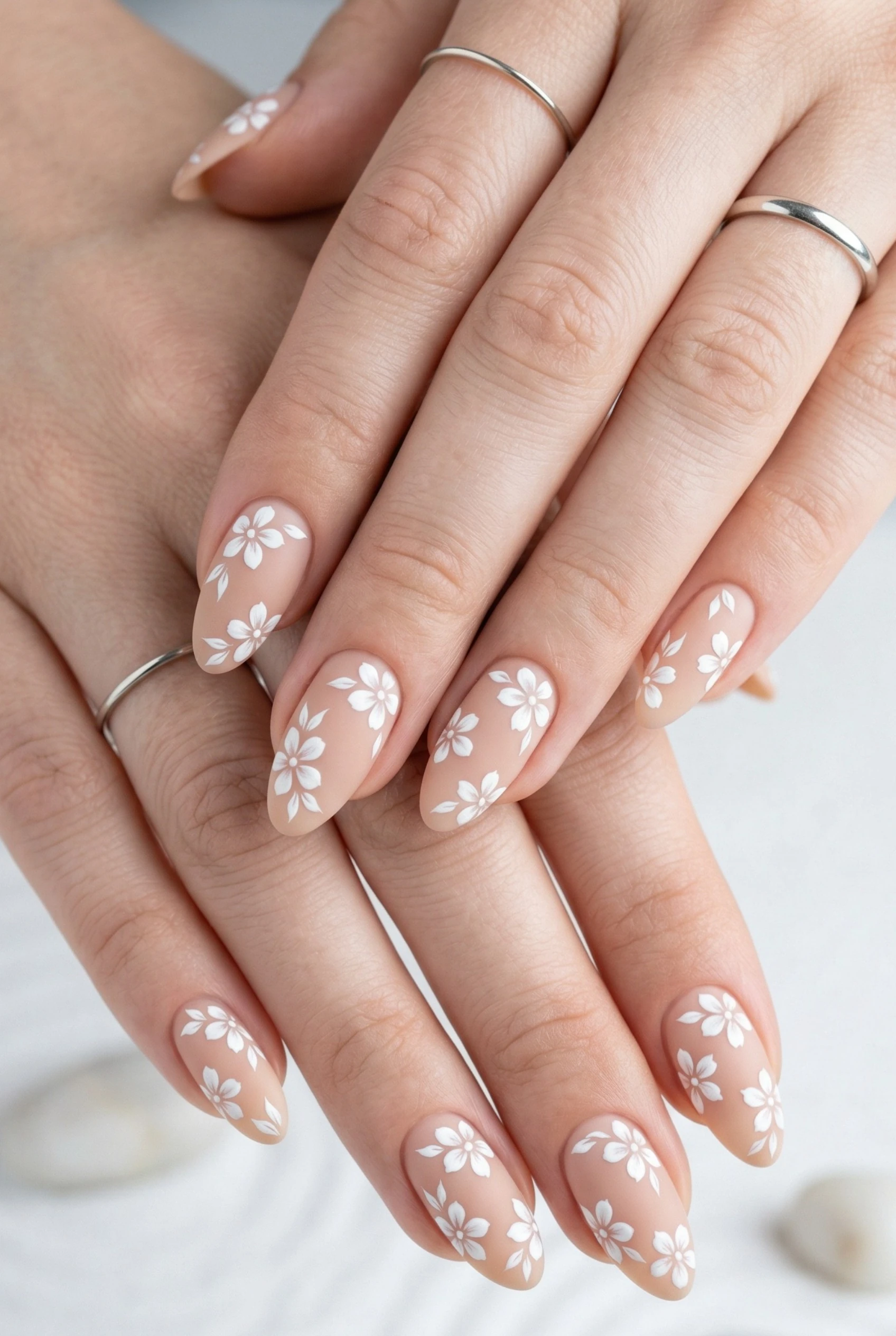 White florals on nude nails