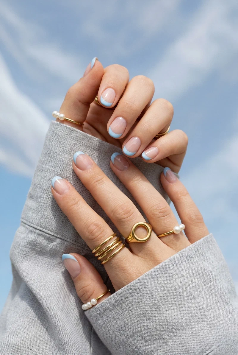 Baby blue french tip nails on short round nails