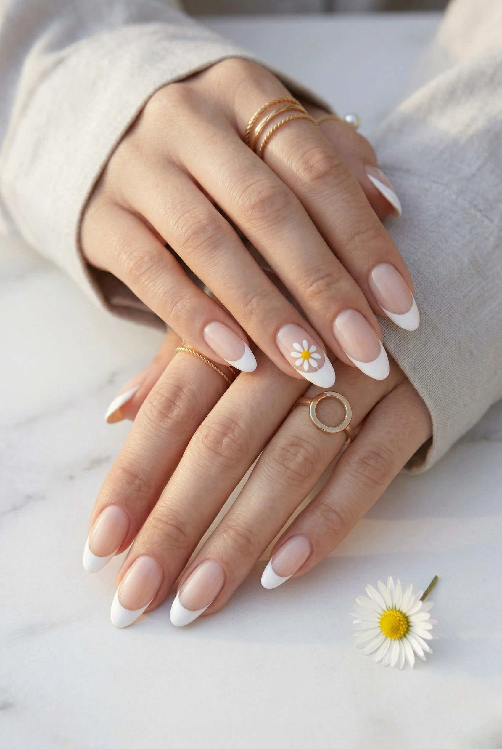 Classic white French tips with a daisy accent