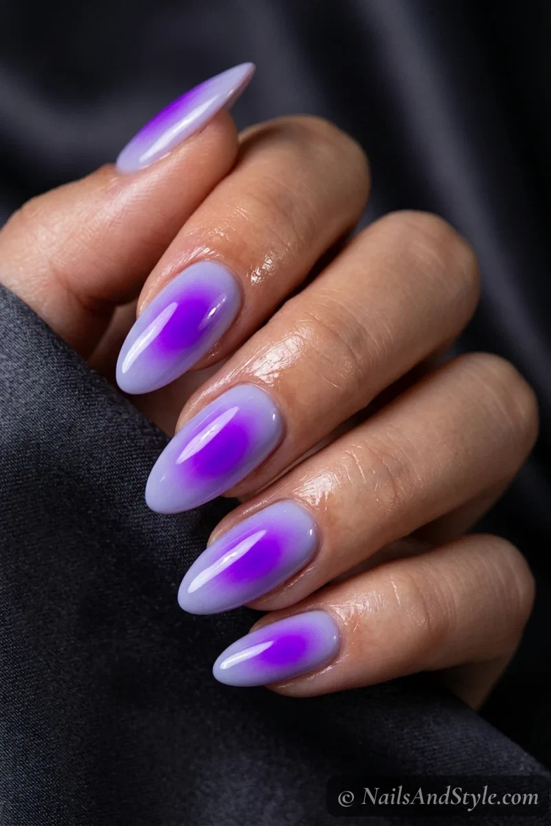 Vivid electric purple aura nails with a high-gloss finish