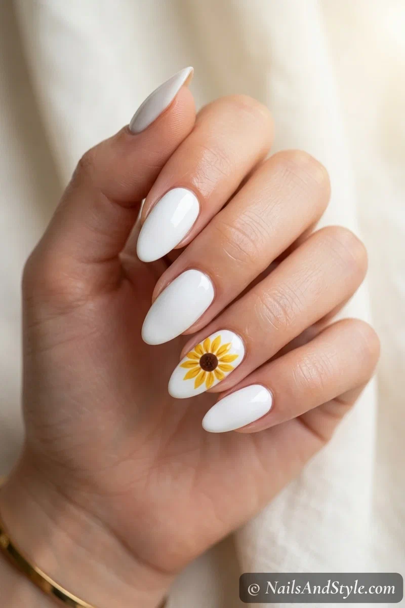 Classic sunflower accent nails with one golden sunflower on a white accent nail, medium almond nails