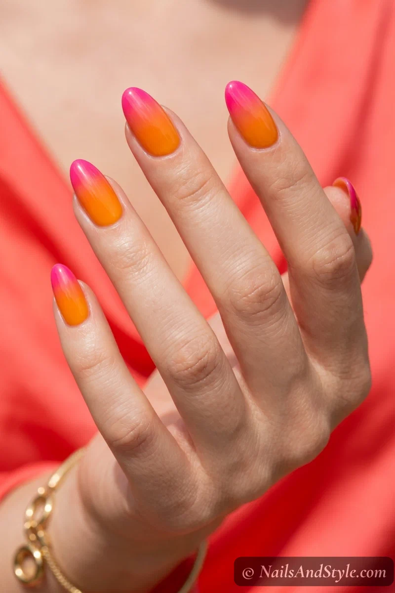 Bright mango to hot pink gradient nails with jelly finish