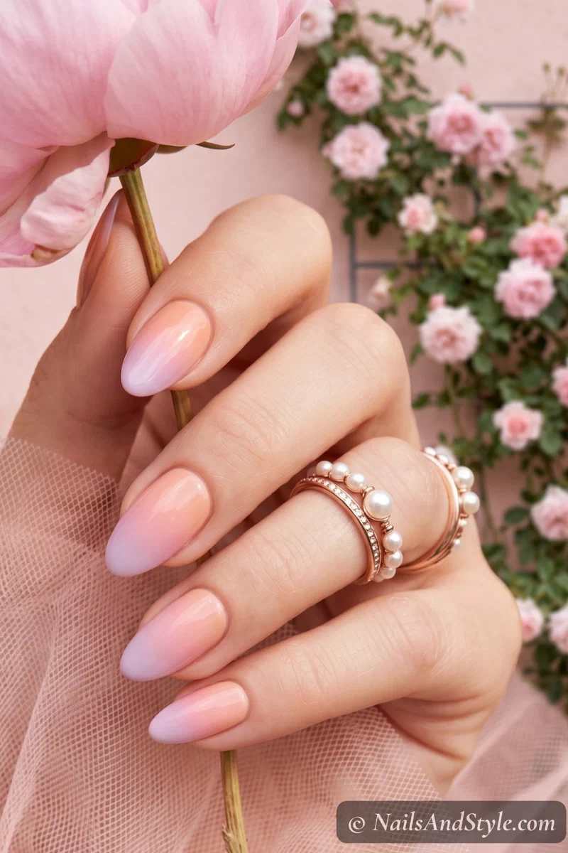 Pastel sunset ombre nails in soft peach pink and lilac on medium nails