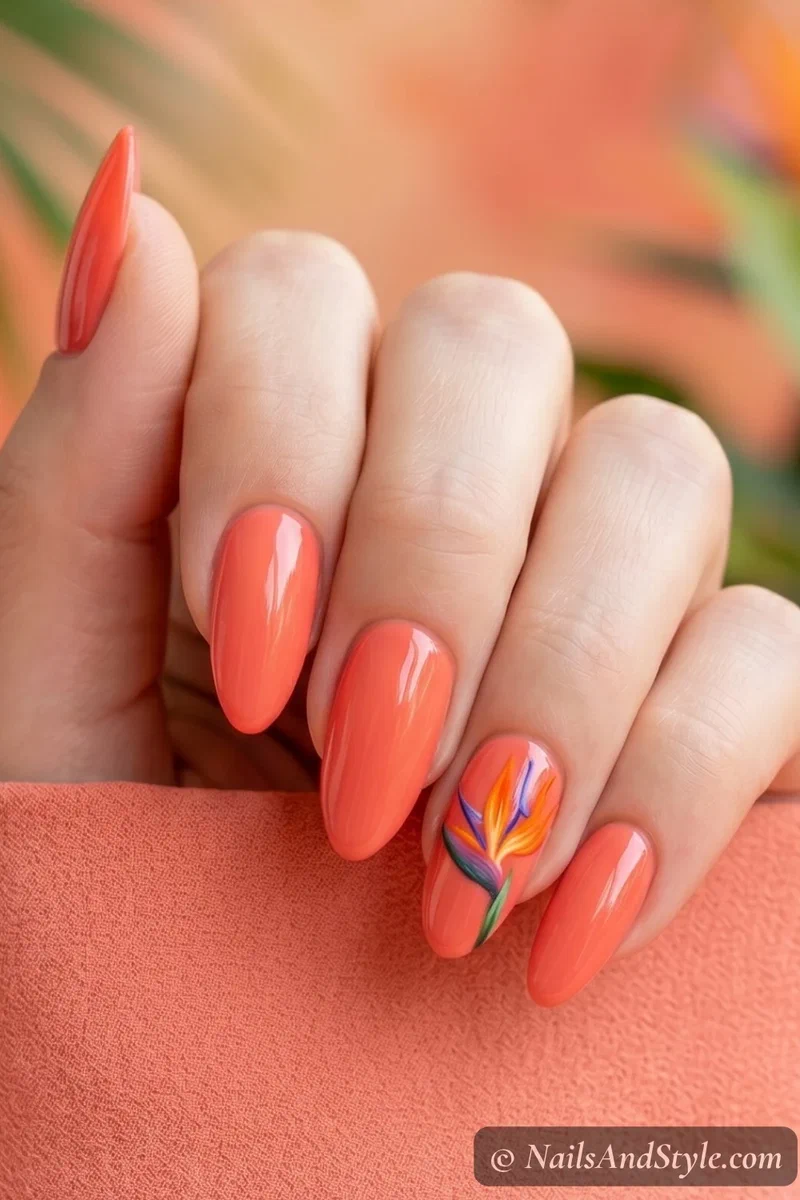 Coral nails with a hand-painted bird of paradise flower on the accent nail