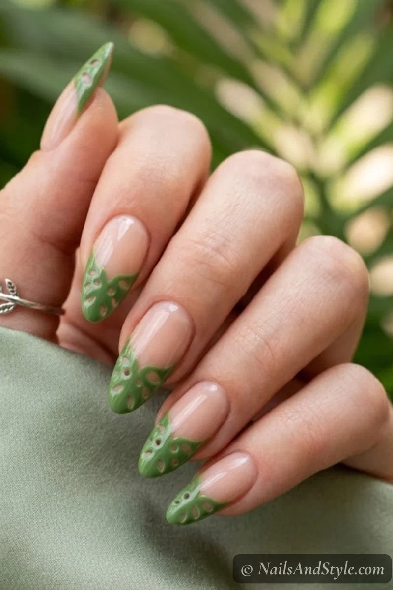 French tip nails with green monstera leaf shaped tips and cutout details