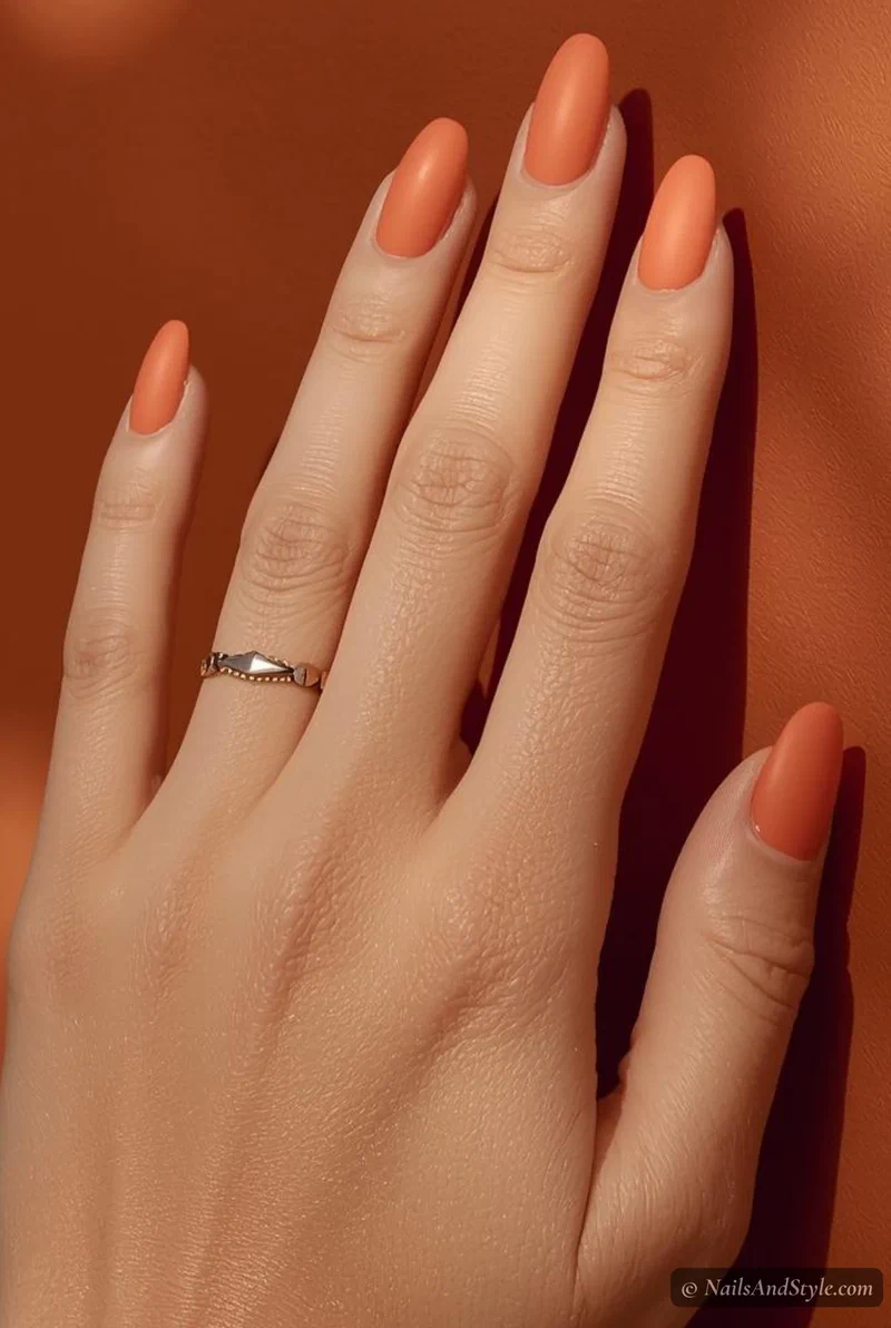 Matte mango sorbet peach-orange nails on medium almond nails