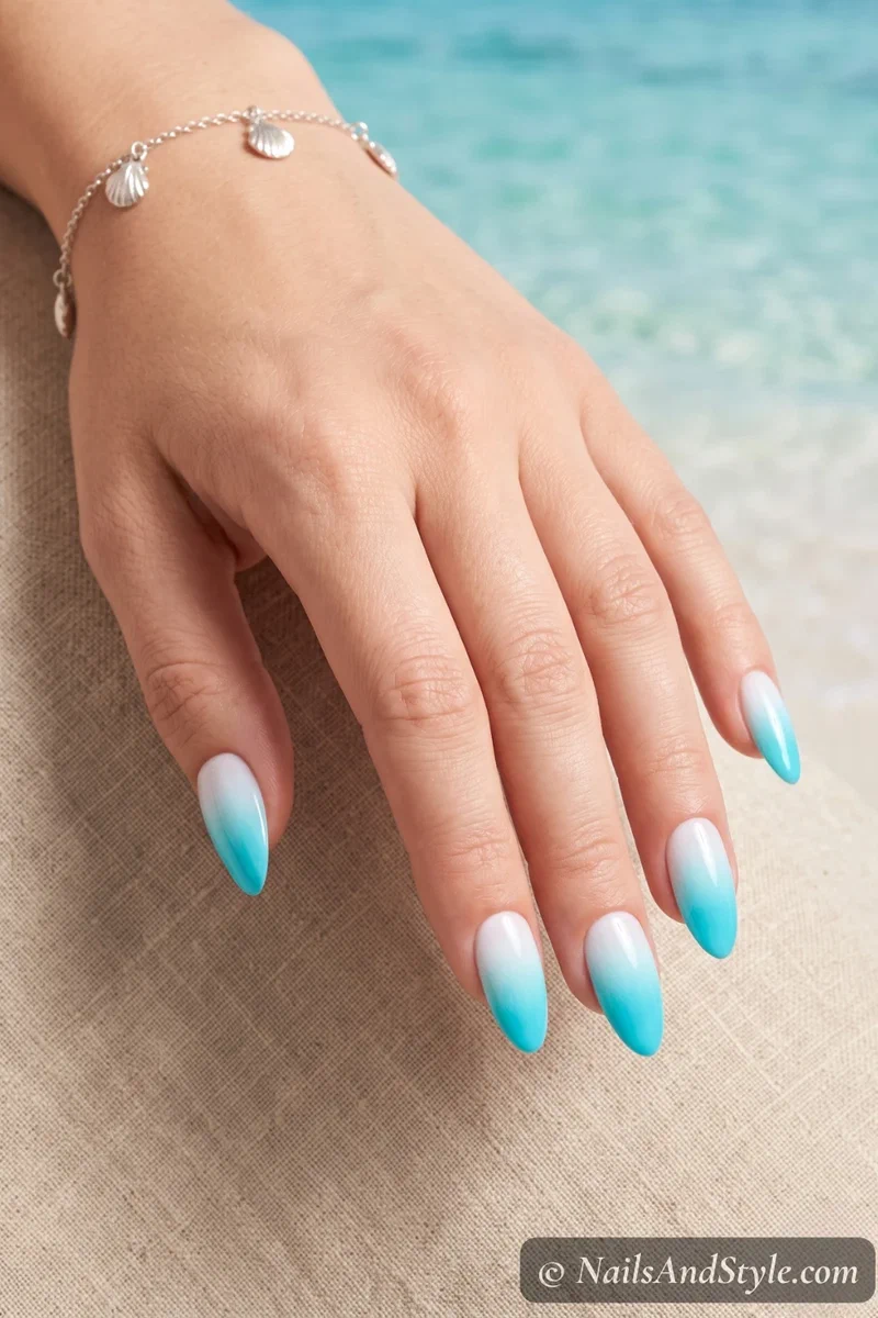 Aqua to white ombre gradient nails with smooth blended transition