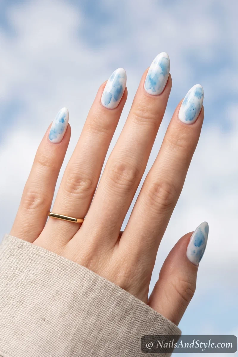 White base nails with soft azure blue watercolor wash effect