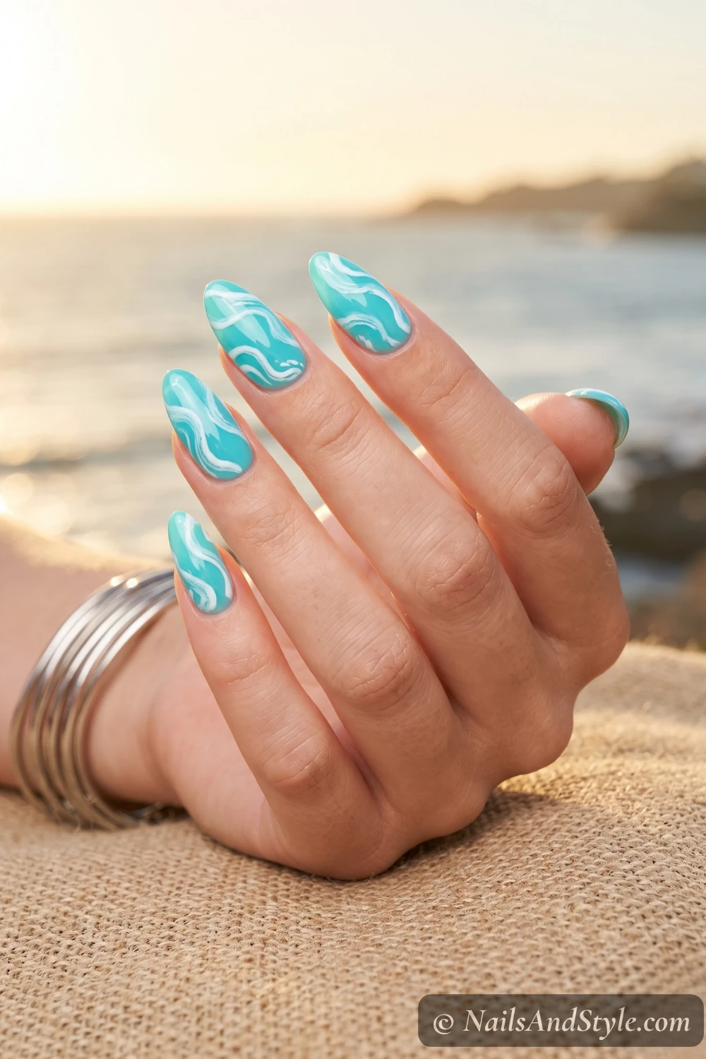 Turquoise nails with white wave swirls