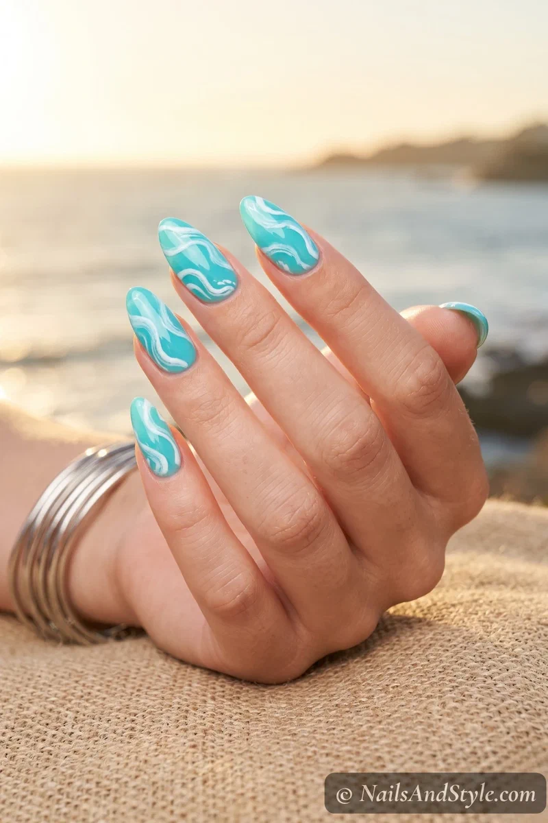 Turquoise nails with white swirling ocean wave patterns